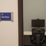 A "quiet Room" sign by a door opening