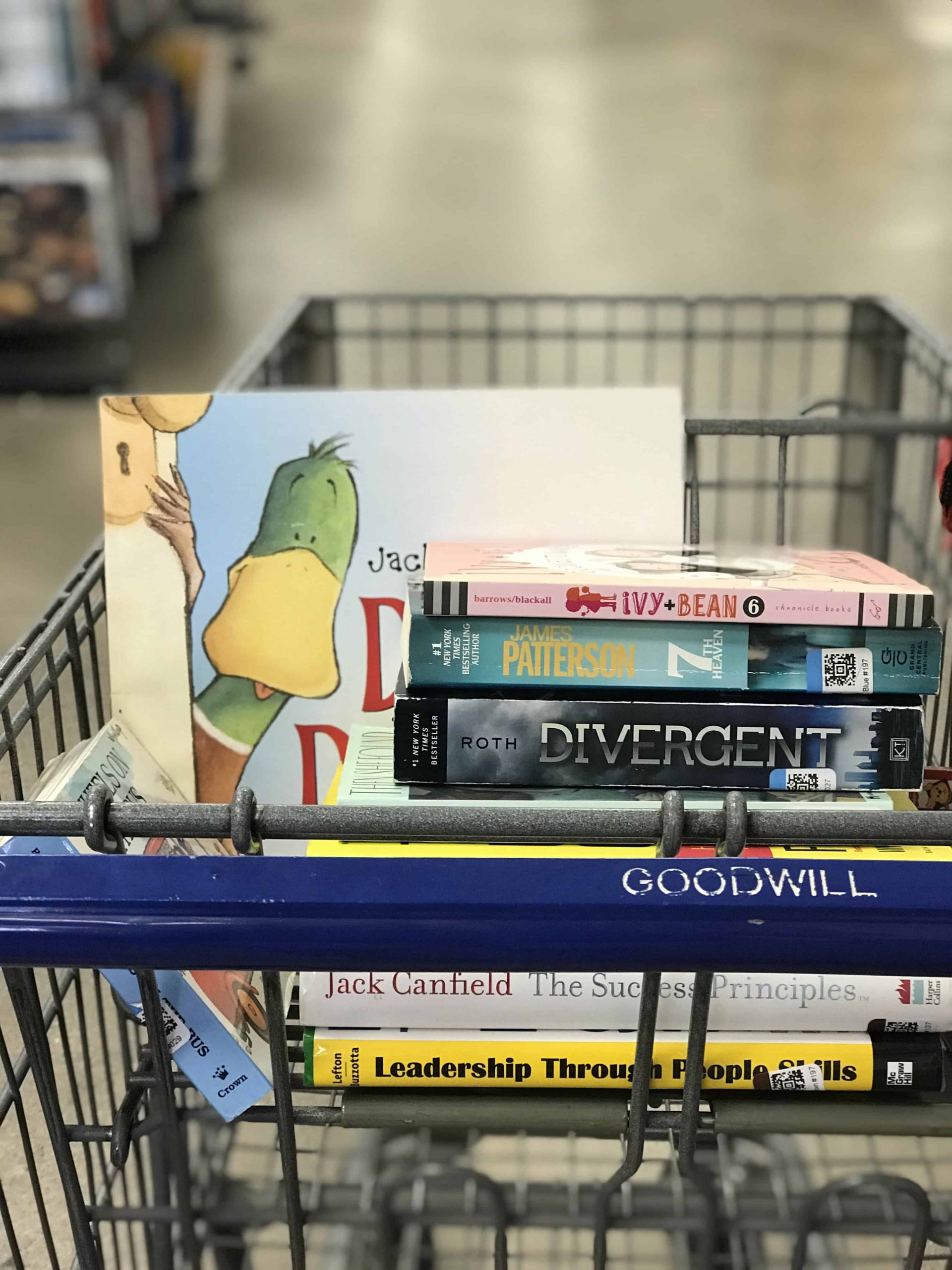 Goodwill AZ | Someone looking through racks of white shirts on hangers