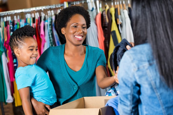 Goodwill AZ | Women holding her child looking at clothes