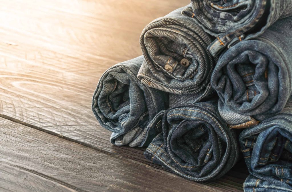 Goodwill AZ | 6 pairs of rolled up jeans stacked in a pyramid