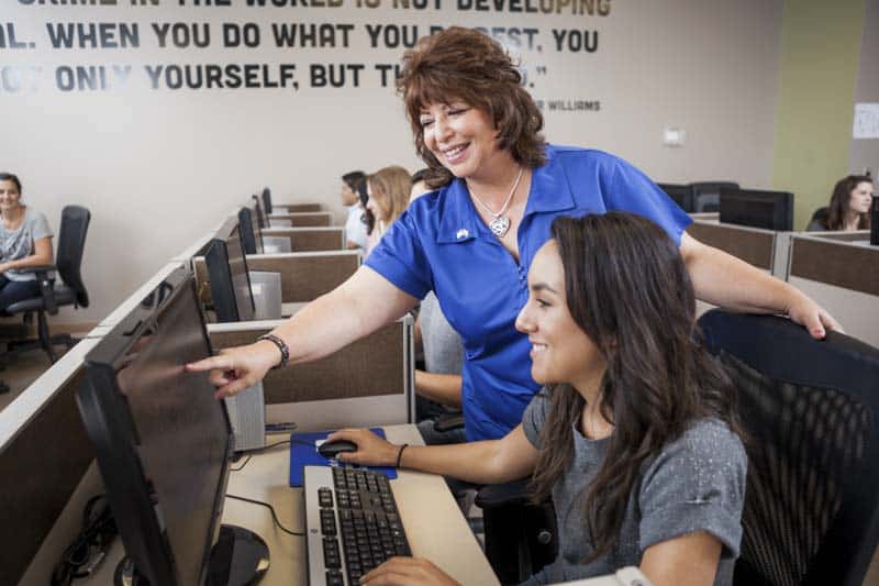 Goodwill AZ | Women pointing at a computer