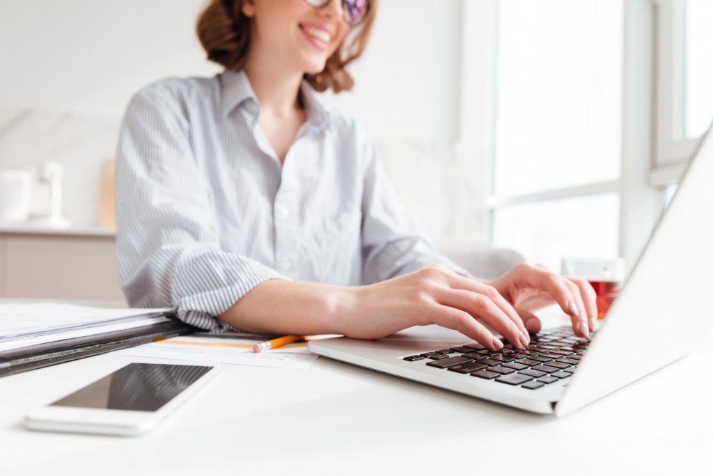 Goodwill AZ | woman typing on computer at home