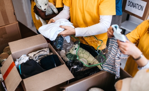 Goodwill AZ | People folding clothes into boxes