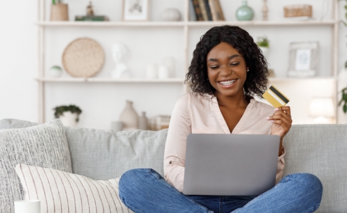 Goodwill AZ | women holding a credit card and laptop