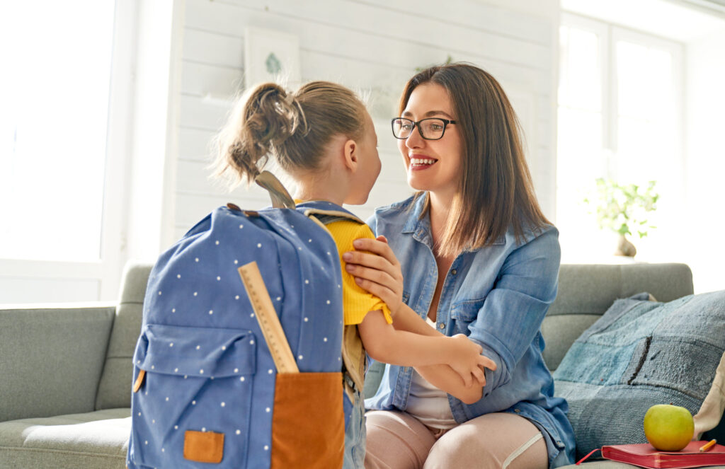 Women and little girl with a backpack on