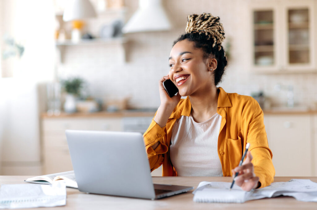 A women talking on a cell phone and holding a pen