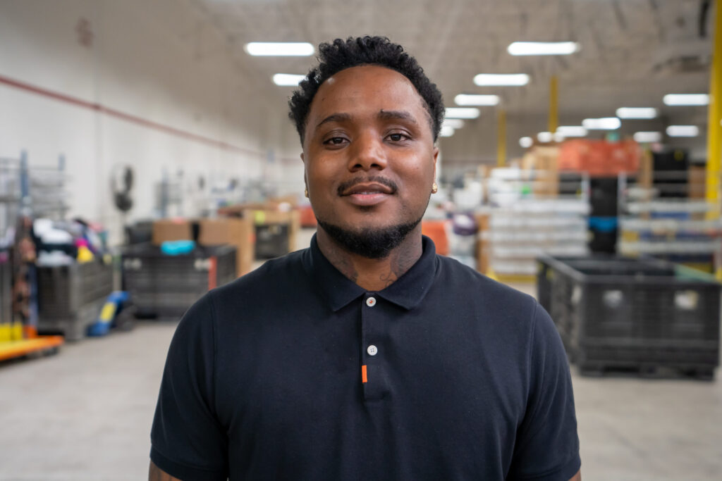 Employee at Goodwill standing in a warehouse